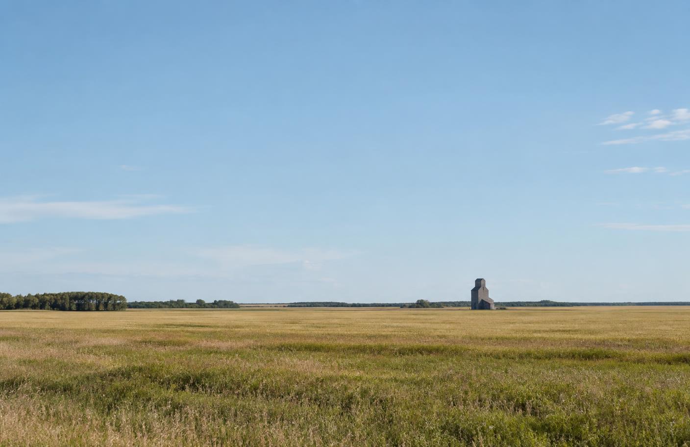 Open Manitoba prairie under a wide blue sky